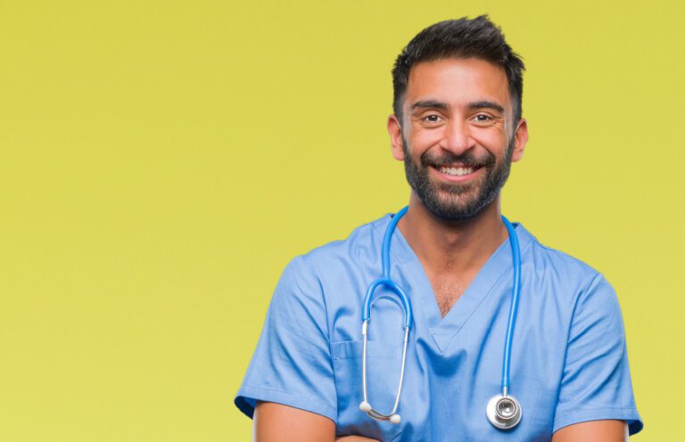 Adult hispanic doctor or surgeon man over isolated background happy face smiling with crossed arms looking at the camera. Positive person.